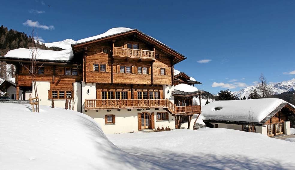 An impressive luxury chalet surrounded by a winter wonderland