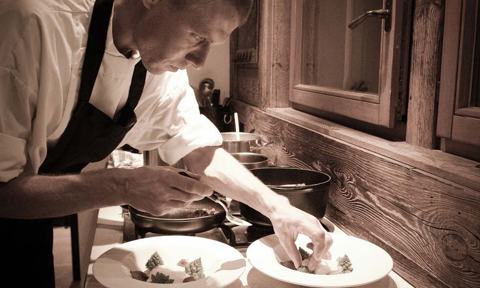 A professional chef preparing the evening meal in a luxury chalet